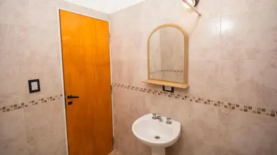 a bathroom with a sink and a mirror at Cabaña El Candil Solo Familias in Villa Carlos Paz
