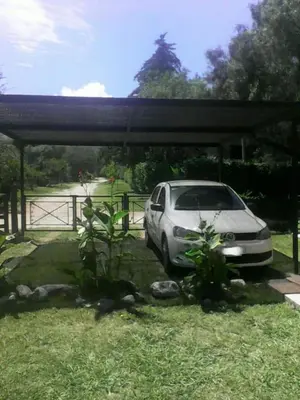 a car parked under a cover in a yard at Los Damascos in Merlo