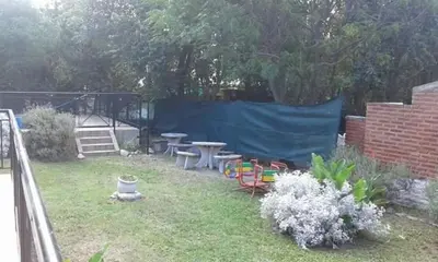 a yard with tables and chairs and a fence at Los Damascos in Merlo