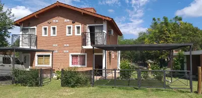 a house with a fence in front of it at Los Damascos in Merlo
