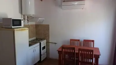 a small kitchen with a table and a microwave at Los Damascos in Merlo