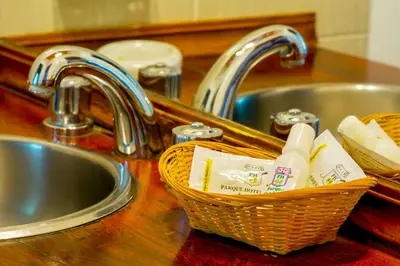 a kitchen counter with a sink and a basket of butter at Hotel Parque in Merlo