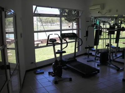a room with a gym with exercise equipment and windows at Hotel Parque in Merlo