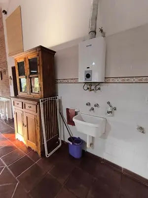 a bathroom with a sink and a wooden cabinet at Los Condores in La Bolsa