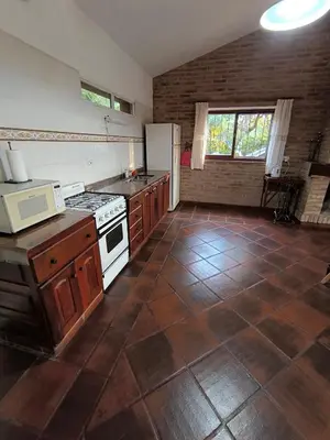 a kitchen with a stove and a refrigerator at Los Condores in La Bolsa