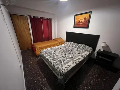 a bedroom with two beds in a room at Luluara in Villa Carlos Paz