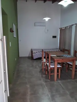 a dining room with a wooden table and chairs at Complejo de Cabañas Los Virreyes in Cerro de Oro