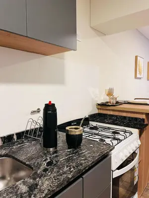 a kitchen with a stove and a sink at Guarida Güemes in Cordoba