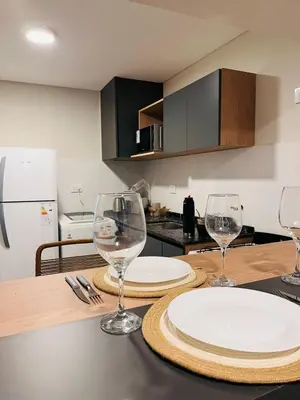 a kitchen with two empty wine glasses on a table at Guarida Güemes in Cordoba