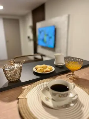 a table with a cup of coffee and a plate of food at Guarida Güemes in Cordoba