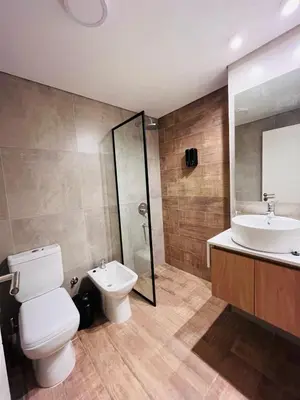 a bathroom with a toilet and a sink and a shower at Guarida Güemes in Cordoba