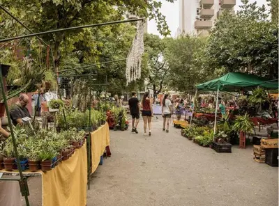 a group of people walking through an outdoor market at Guarida Güemes in Cordoba