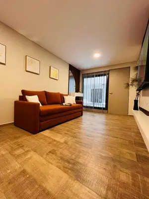 a living room with a couch and a wooden floor at Guarida Güemes in Cordoba