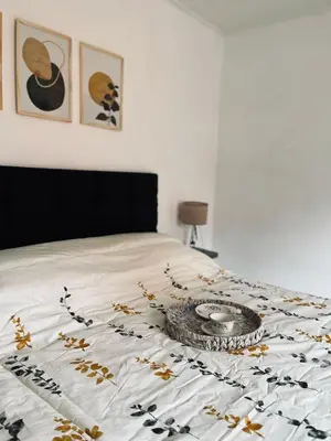 a bed with a comforter with a plate on it at AMOBLADOS CORDOBA - Centro Histórico in Cordoba