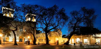 a building with trees in front of it at night at AMOBLADOS CORDOBA - Centro Histórico in Cordoba