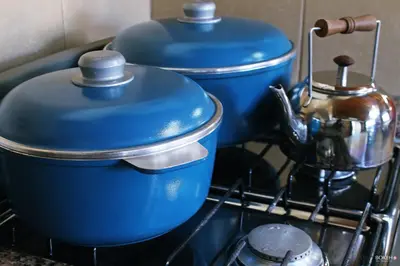 two blue pots and pans sitting on a stove at Posada de las Sierras in Merlo