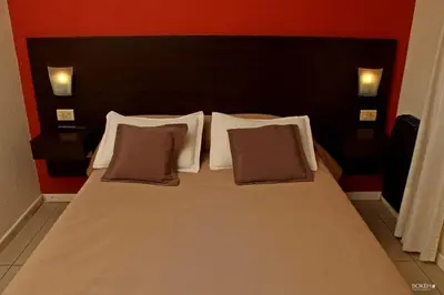 a bedroom with a bed with two pillows at Posada de las Sierras in Merlo