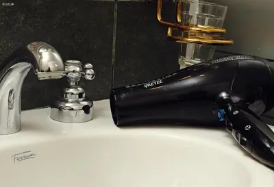 a black faucet sitting on a bathroom sink at Posada de las Sierras in Merlo