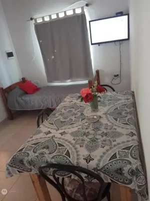 a table with a vase of flowers on top of it at cabañas neli in Santa Rosa de Calamuchita