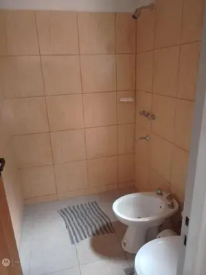a bathroom with a toilet and a sink at cabañas neli in Santa Rosa de Calamuchita