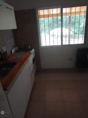 a kitchen with a sink and a window at cabañas neli in Santa Rosa de Calamuchita