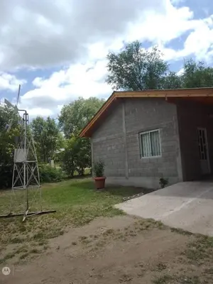 a small brick building with a tower next to it at cabañas neli in Santa Rosa de Calamuchita