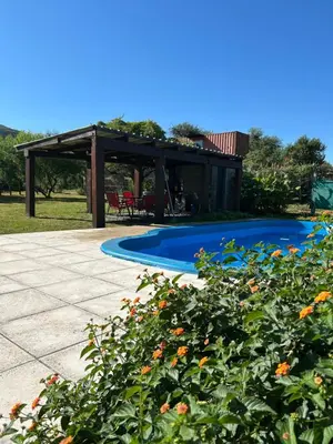 a house with a swimming pool and a pavilion at Amanecer eterno in Cordoba