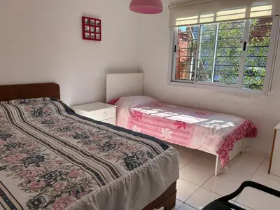 a bedroom with two beds and a window at Amanecer eterno in Cordoba