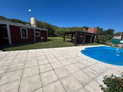 a backyard with a swimming pool and a house at Amanecer eterno in Cordoba