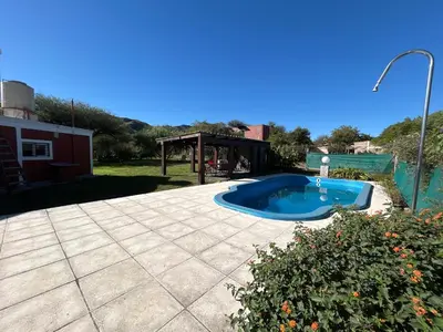 a small swimming pool in a yard with a pavilion at Amanecer eterno in Cordoba