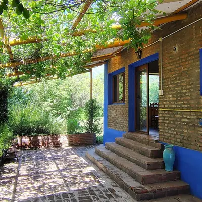 a blue house with stairs leading to a door at La Casa Azul in San Javier