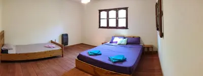 a small room with two beds and a window at La Casa Azul in San Javier