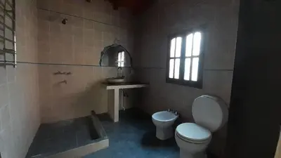 a bathroom with a toilet and a sink at La Casa Azul in San Javier