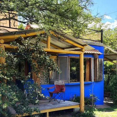 a blue house with a chair on a deck at La Casa Azul in San Javier
