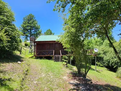a log cabin in the middle of a field at Rincon Soñado in La Porteña