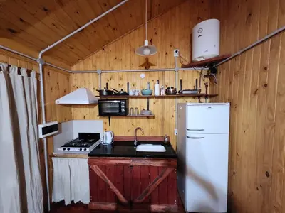 a kitchen with a white refrigerator and a sink at Rincon Soñado in La Porteña