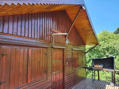 a large wooden building with a wooden deck at Rincon Soñado in La Porteña
