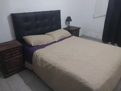a bedroom with a large bed with a black headboard at Mate host 2 in Cordoba
