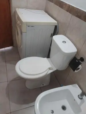 a bathroom with a white toilet and a sink at Mate host 2 in Cordoba