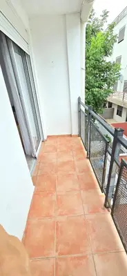 a balcony with a tile floor on a building at La Martina in Villa Carlos Paz