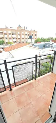 a balcony with a view of a building at La Martina in Villa Carlos Paz