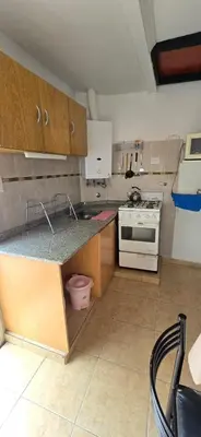a kitchen with a counter top and a stove at La Martina in Villa Carlos Paz