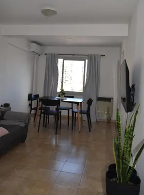 a living room with a table and chairs and a couch at Departamento Abril in Cordoba