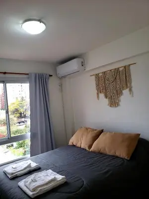 a bedroom with a bed with two towels on it at Departamento Abril in Cordoba