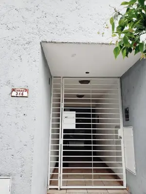 a metal gate on the side of a building at Departamento Abril in Cordoba