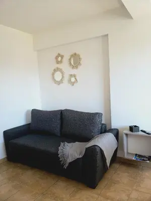 a living room with a couch and plates on the wall at Departamento Abril in Cordoba
