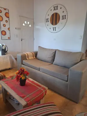 a living room with a couch and a table at Casa Manantiales in Villa General Belgrano