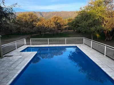 a swimming pool with a white fence around it at Cabañas Paz in Carpintería
