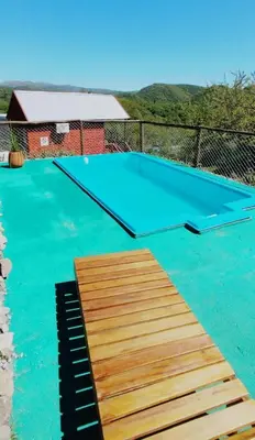 a trampoline in the middle of a swimming pool at CUYEN LA SERRANITA Dormi DLX Cabin para 2 Personas in Villa Serranita
