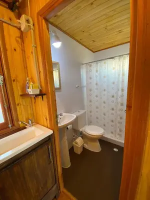 a bathroom with a toilet and a sink at CUYEN LA SERRANITA Dormi DLX Cabin para 2 Personas in Villa Serranita